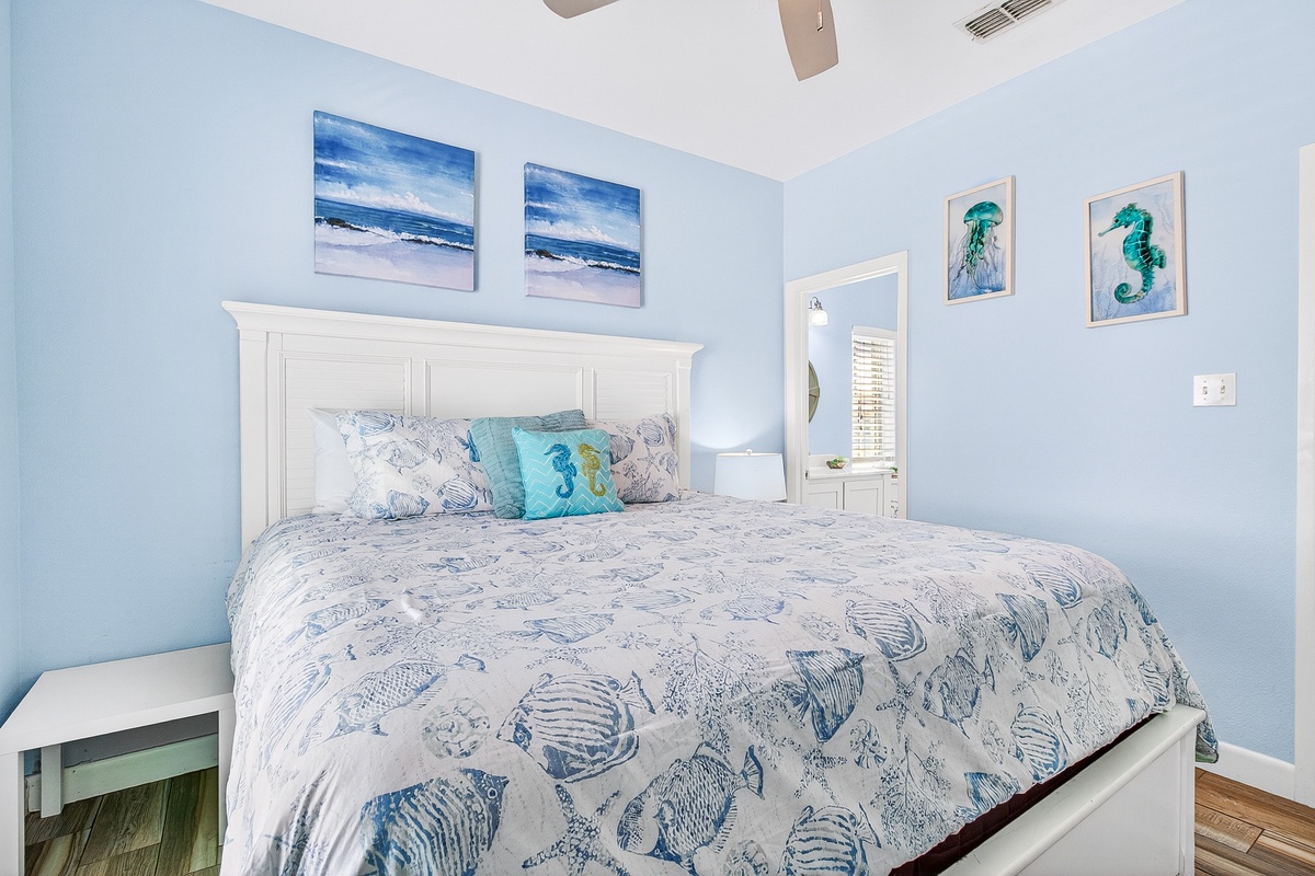 Drift off peacefully in your coastal-themed bedroom, where soothing blue walls and ocean-inspired artwork create your perfect seaside sanctuary.