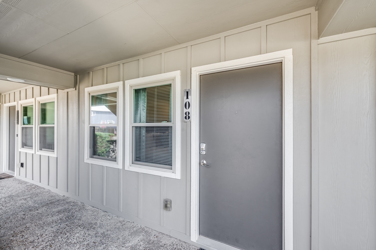 Exterior entrance to unit 108 with clean architectural lines and covered walkway for comfortable arrival.