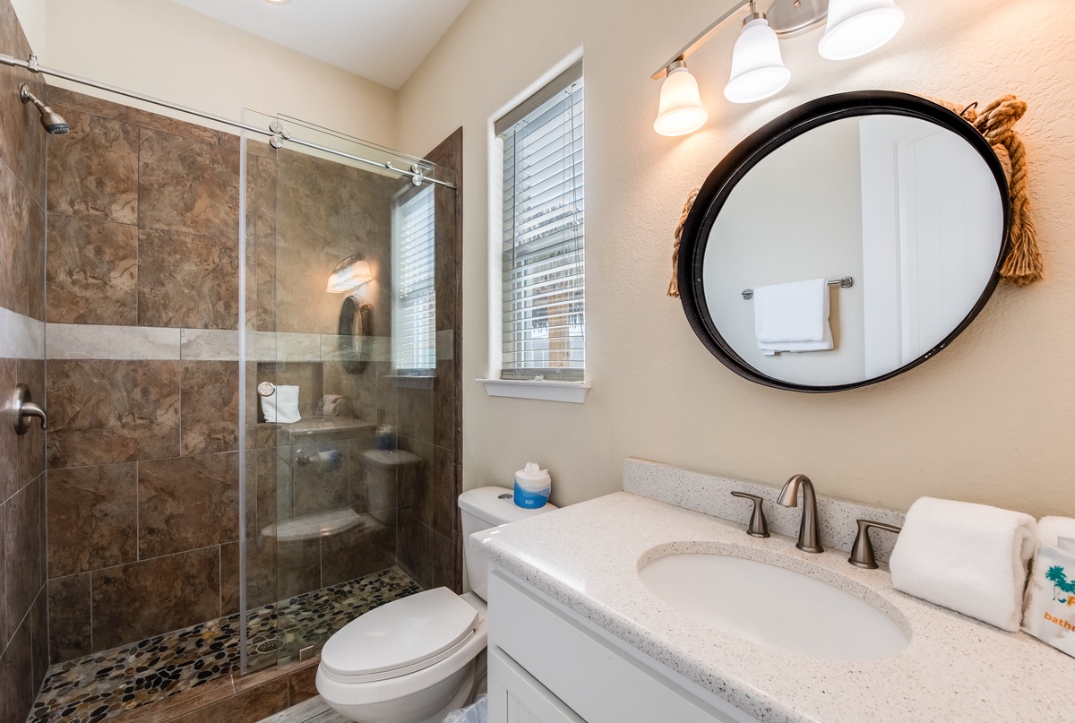 Refresh in your beautifully appointed bathroom featuring a spacious walk-in shower, elegant vanity, and thoughtful touches for your comfort.