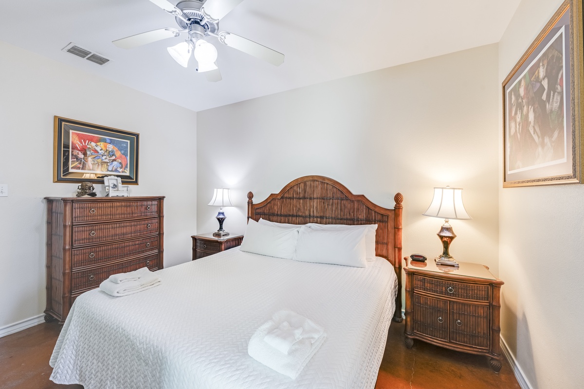 Drift off in your cozy bedroom with elegant wicker furniture, soft linens, and warm bedside lighting creating the perfect sanctuary for restful nights.