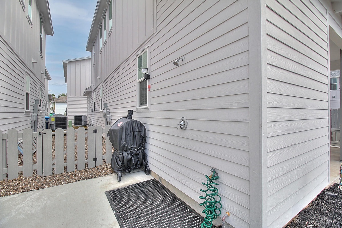 Convenient outdoor space with covered grill and water hookup for your beachside cooking adventures.