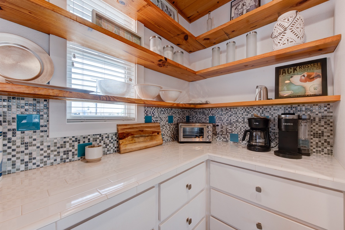 Your fully equipped kitchen features beautiful wood beams, mosaic backsplash, and everything you need for memorable meals.