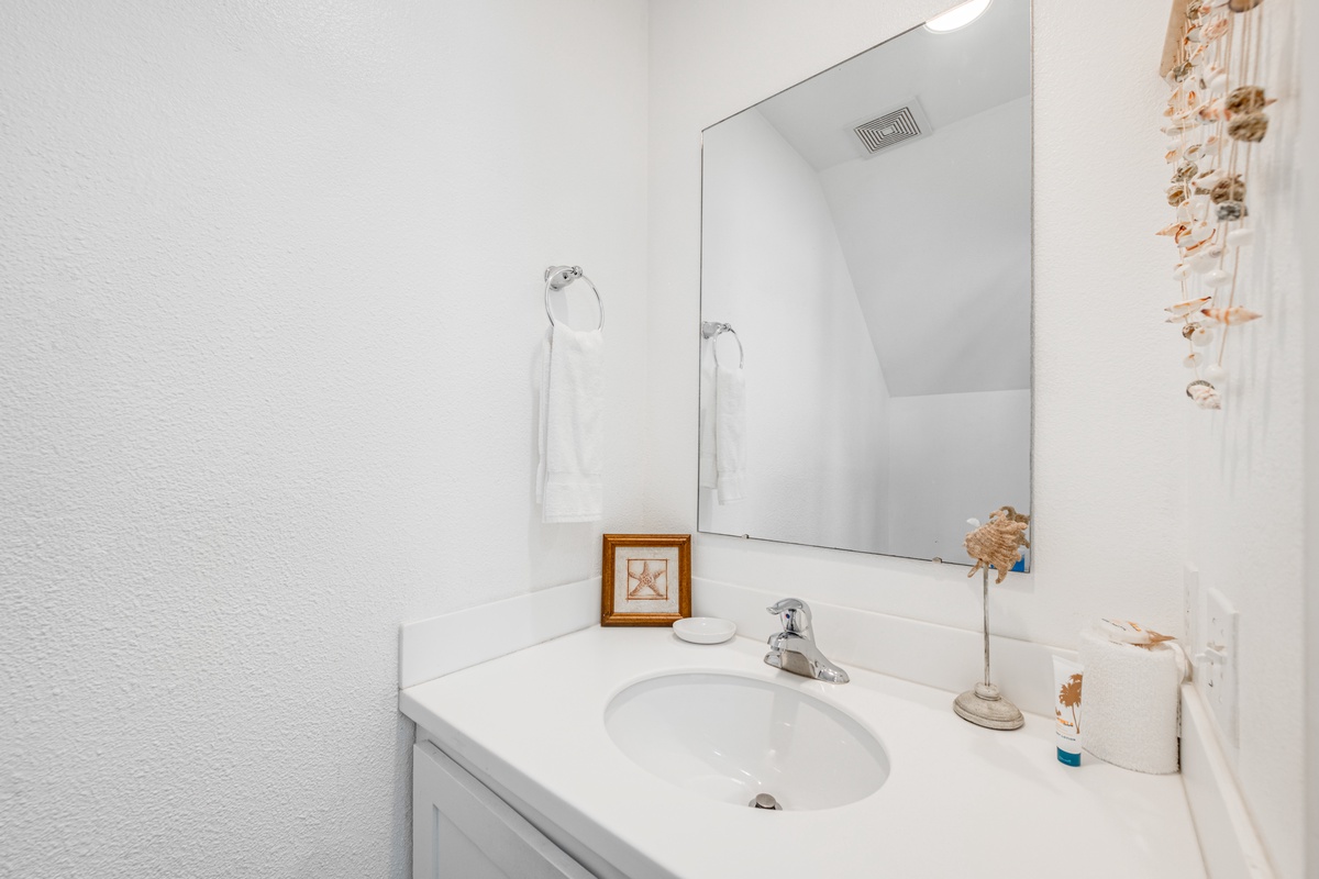 Your clean, bright bathroom features coastal touches and thoughtful amenities to make your morning routine feel refreshing and unhurried.