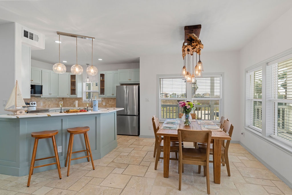 Your bright, open kitchen flows into the dining area where you'll create memories over home-cooked meals beneath warm pendant lighting.