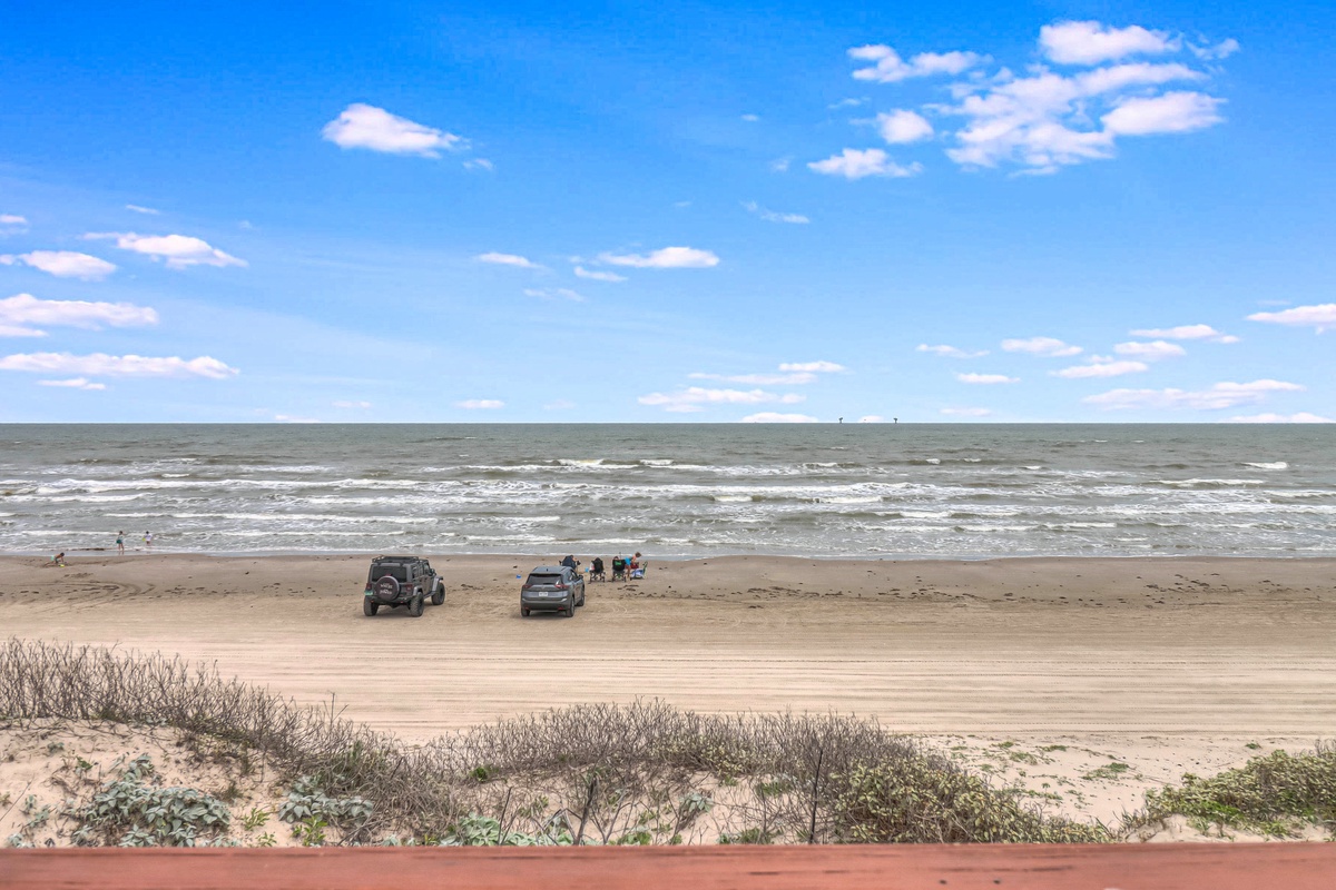 Expansive beachfront with sandy shores and rolling waves, offering direct access to coastal adventures and seaside relaxation.