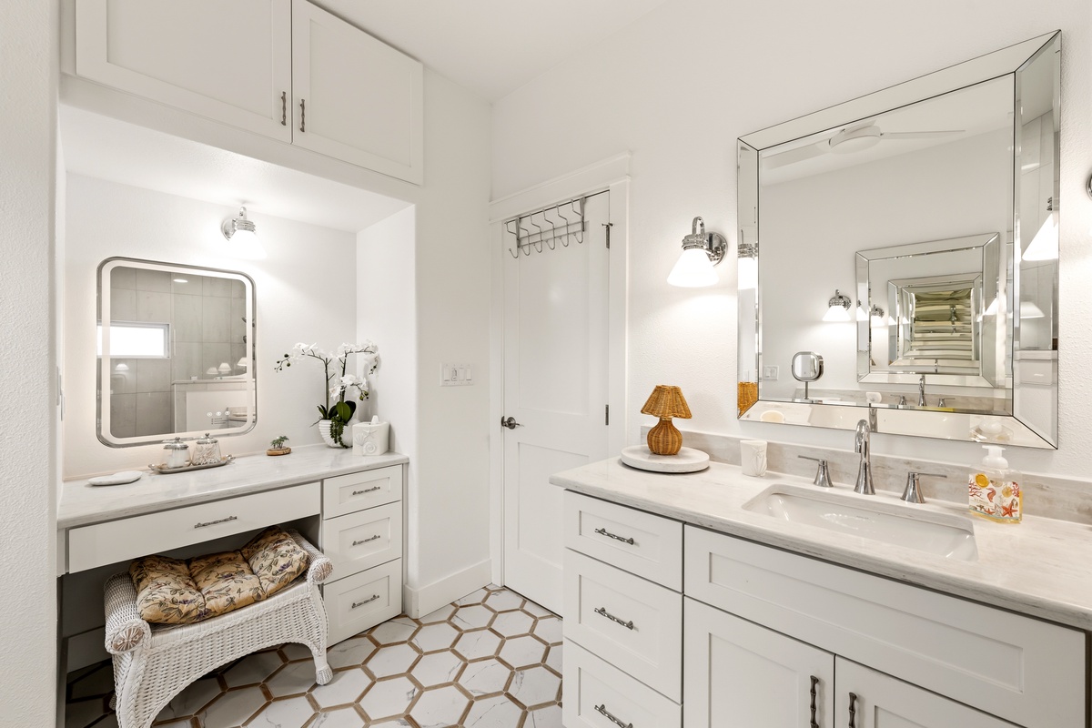 Step into your serene spa-like bathroom, where gleaming white vanities and elegant mirrors create the perfect morning retreat. The geometric tile adds charm underfoot while you prepare for your day.