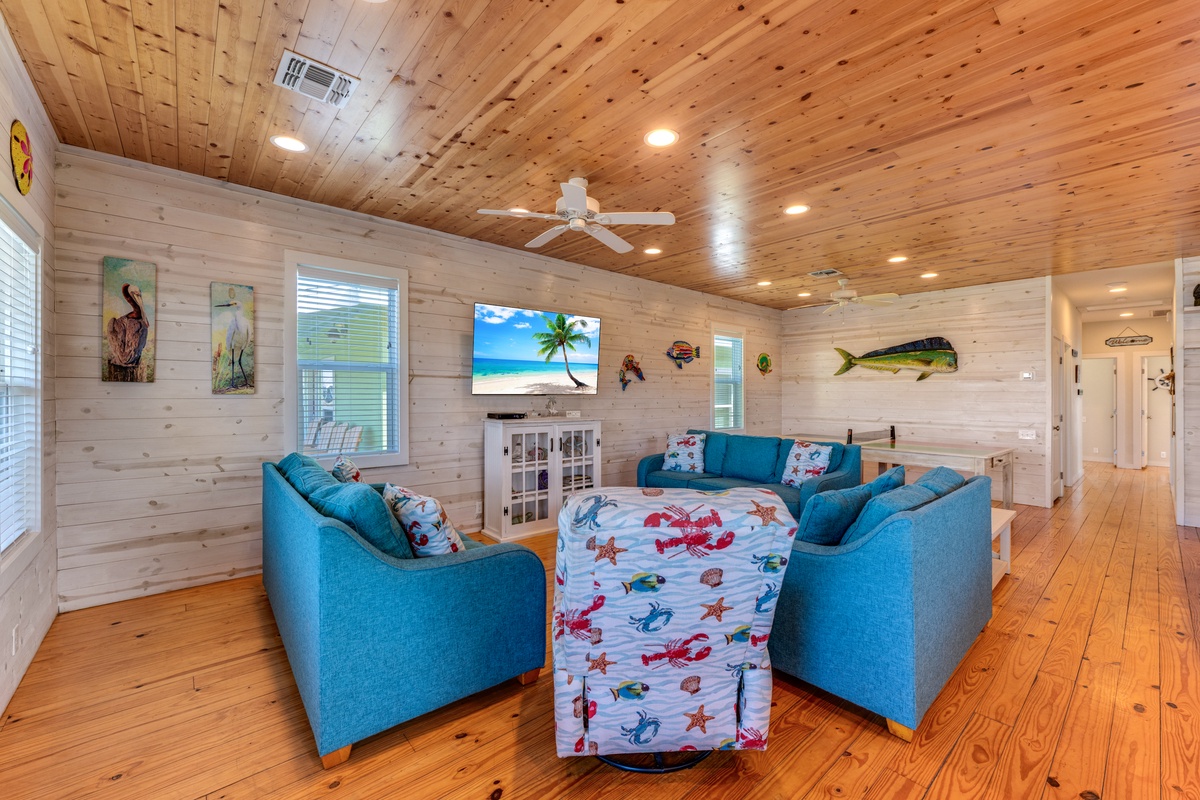 Your coastal living room features turquoise seating and warm wood accents, creating the perfect space to unwind after beach days.
