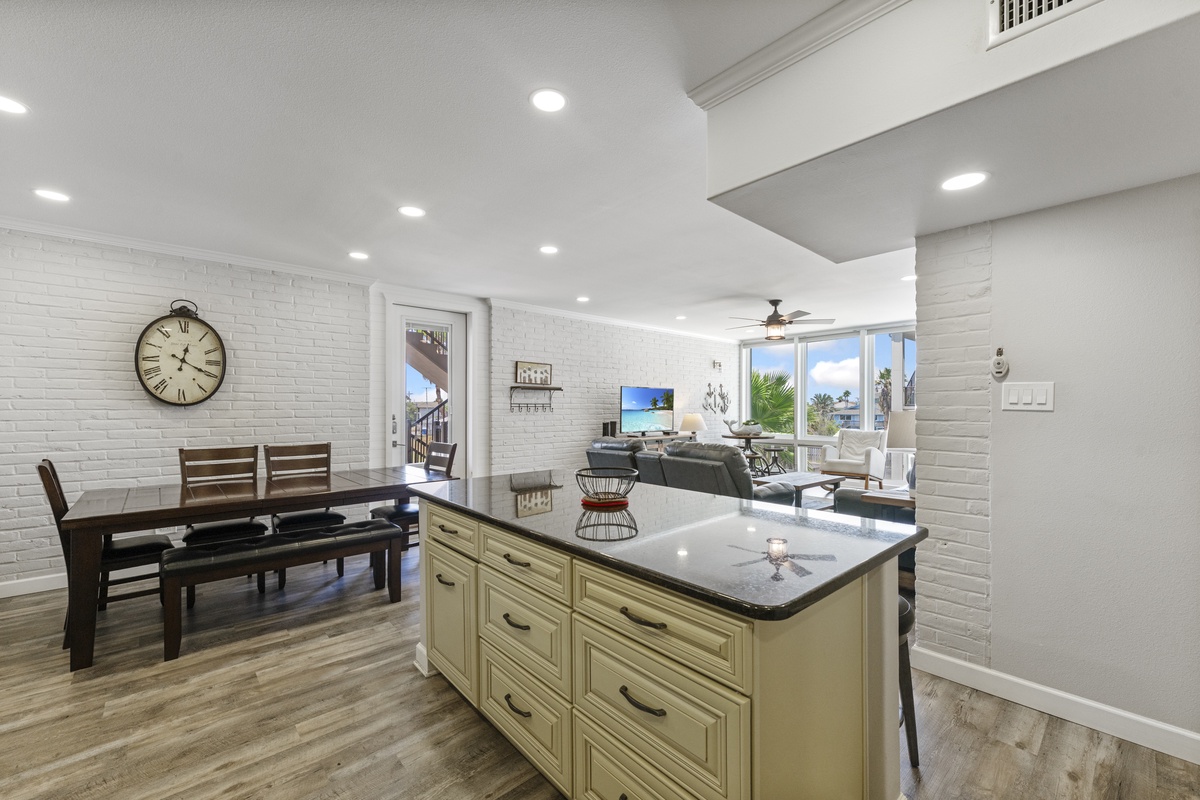 Your open-concept kitchen flows seamlessly into the dining and living areas, creating a bright, welcoming space perfect for gathering and relaxation.