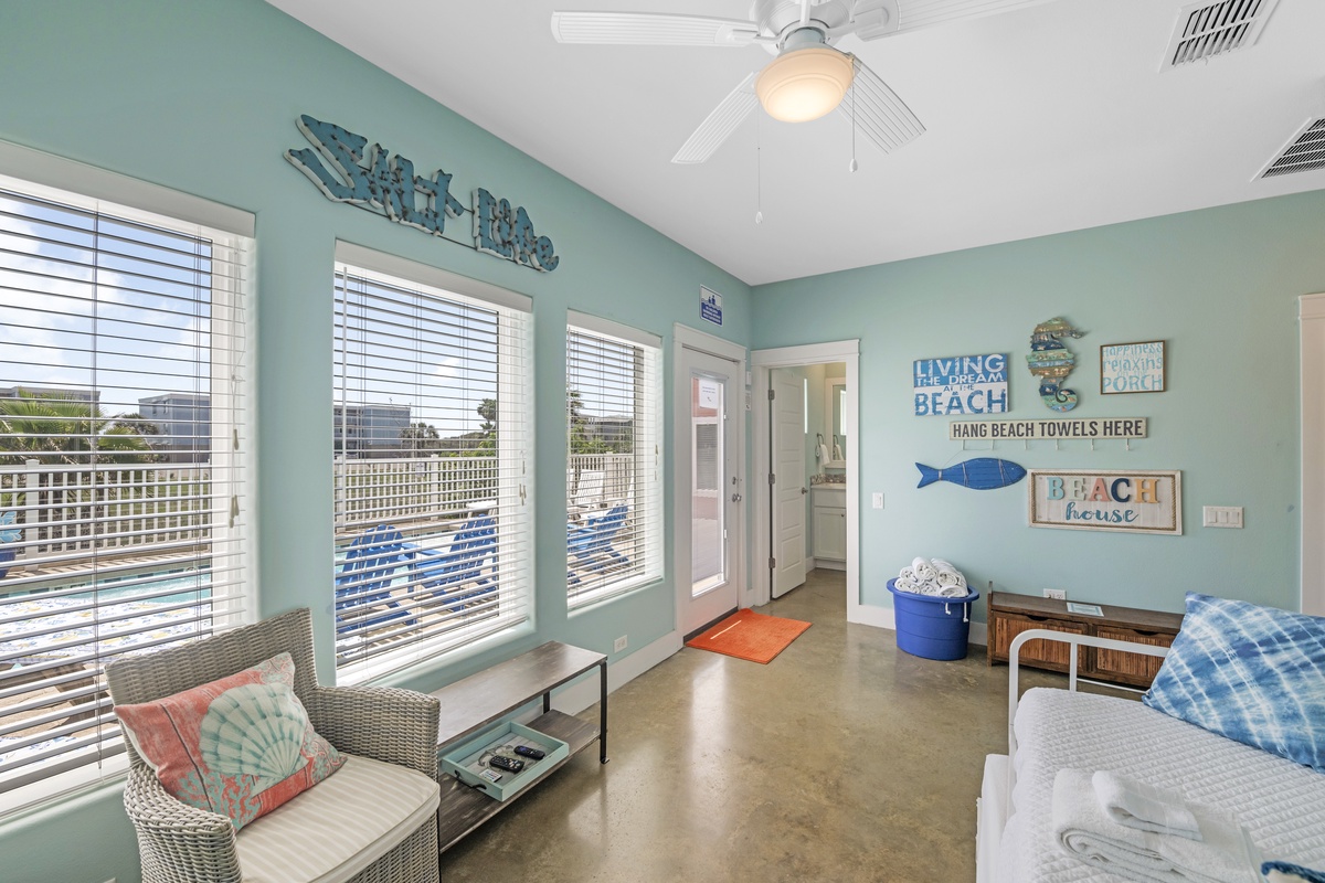 Unwind in this charming beach-themed room with coastal decor, comfy seating, and cheerful blue accents that welcome you home.