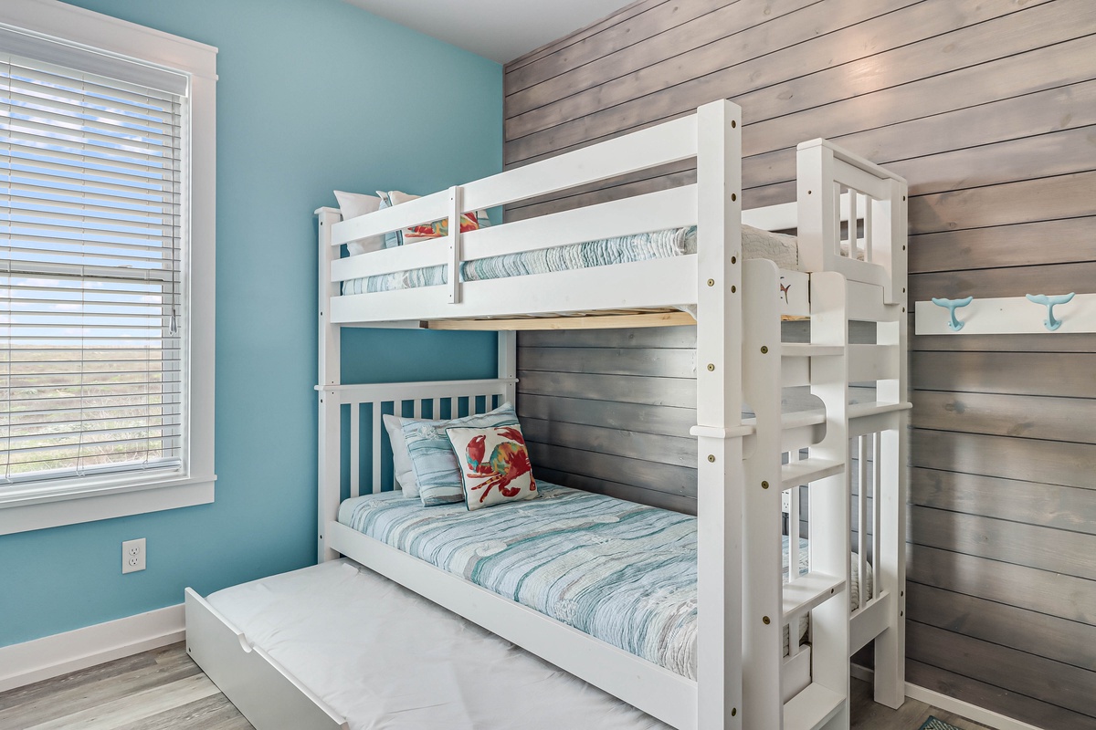 Your coastal-themed bunk room offers comfortable sleeping for the kids, with charming nautical details and a cozy hideaway trundle bed below.