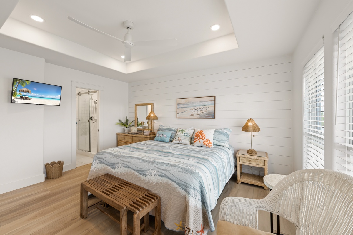 Unwind in your serene coastal retreat, where shiplap walls and soft ocean-inspired tones create a calming sanctuary. The comfortable bed and thoughtful touches invite you to relax after a day of adventure.