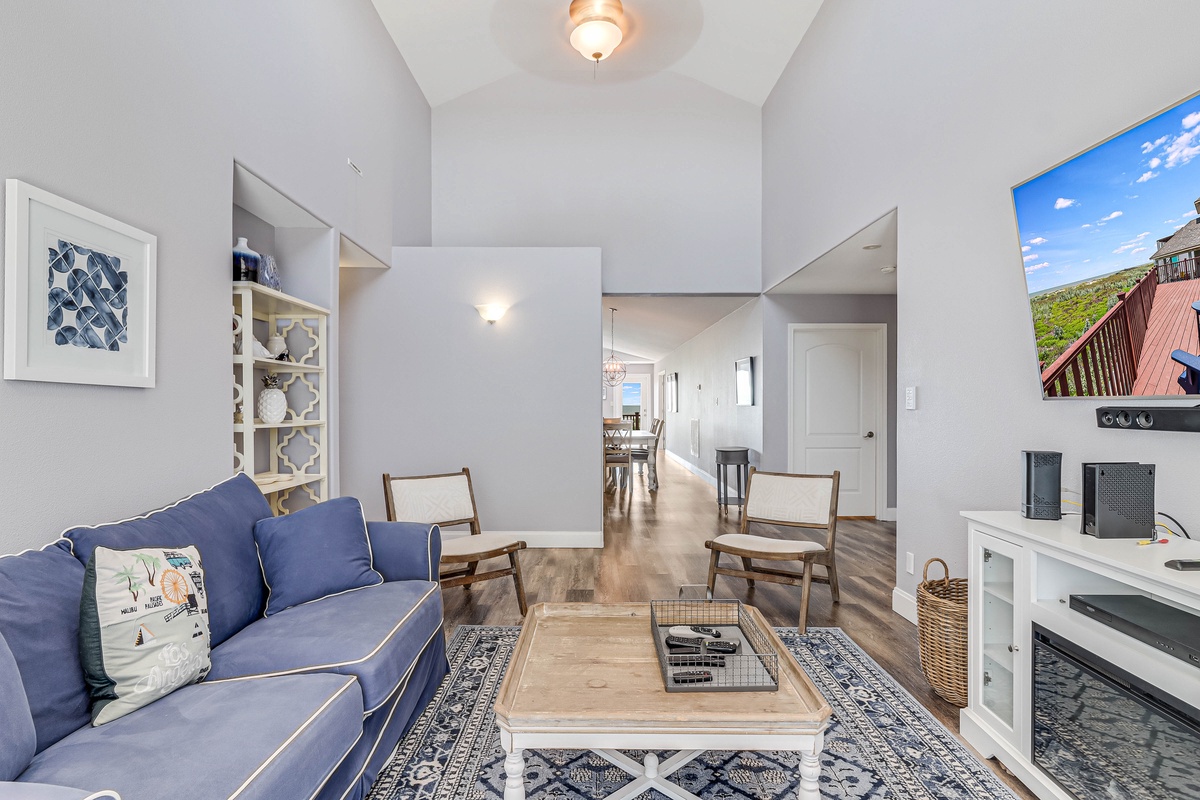 Relax in your bright, open living space with comfortable blue sofa and stylish furnishings—perfect for unwinding after exploring.
