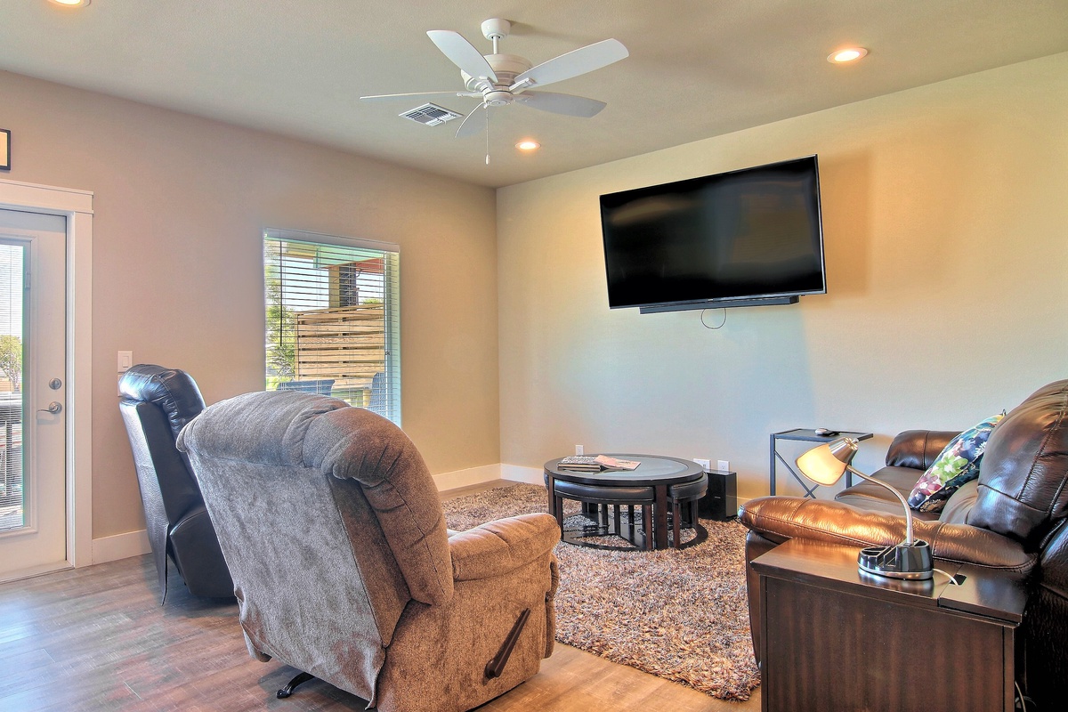 Sink into plush recliners while you catch your favorite shows on the wall-mounted TV. This cozy living room is your perfect retreat spot.