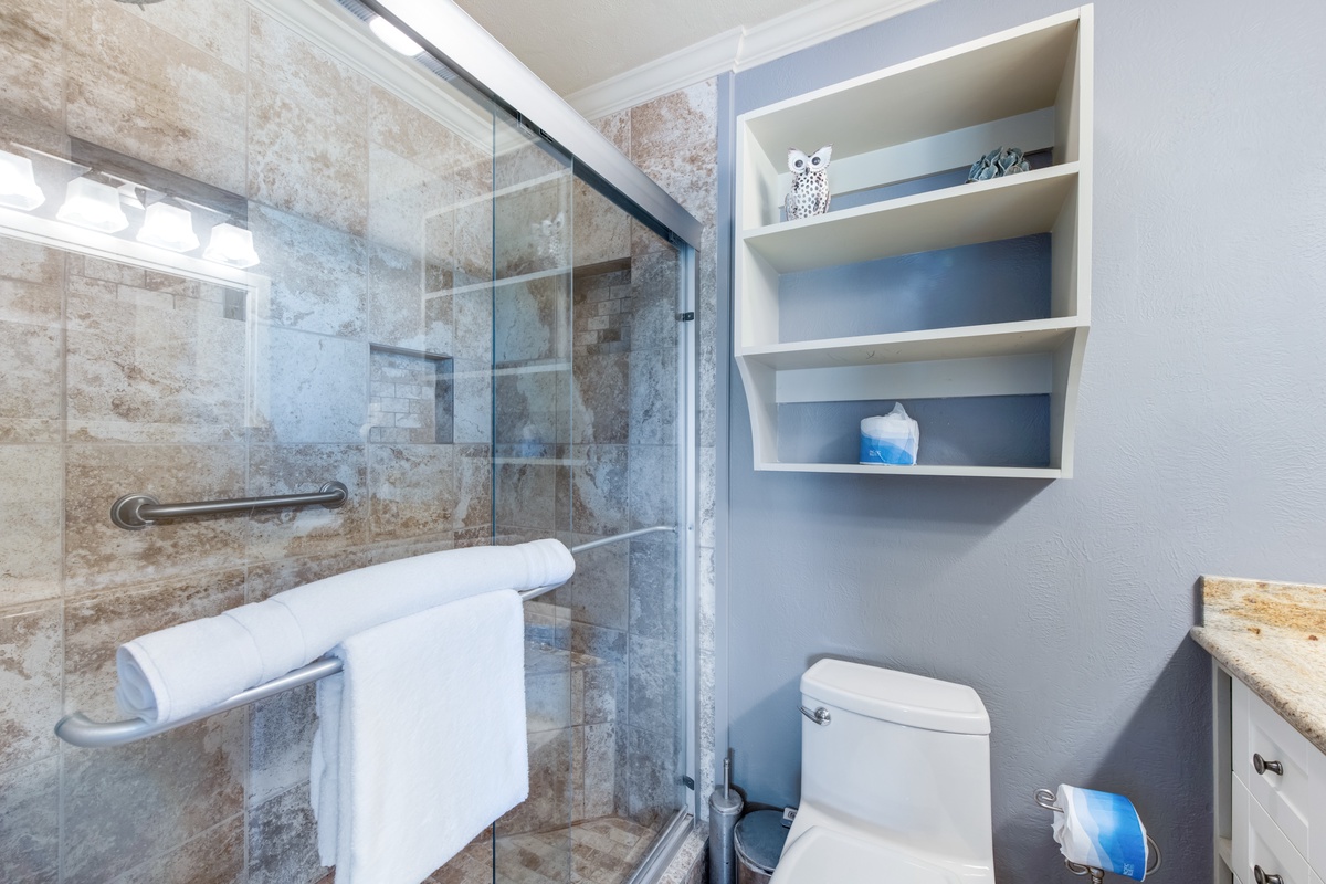 Unwind in your spa-like bathroom with luxurious stone-tiled shower and built-in storage for all essentials.