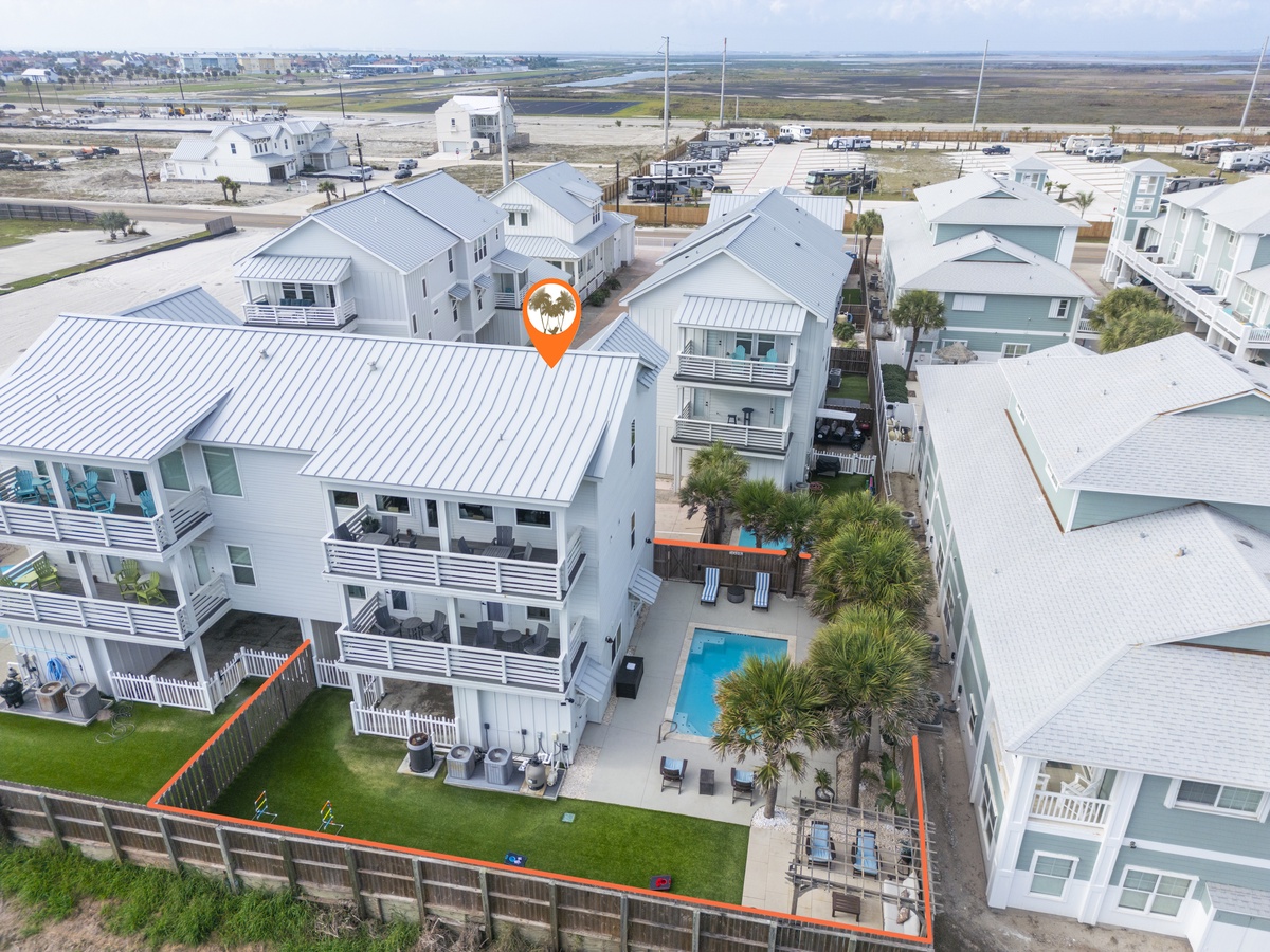 Coastal vacation home with private pool and expansive yard in residential beachside community.