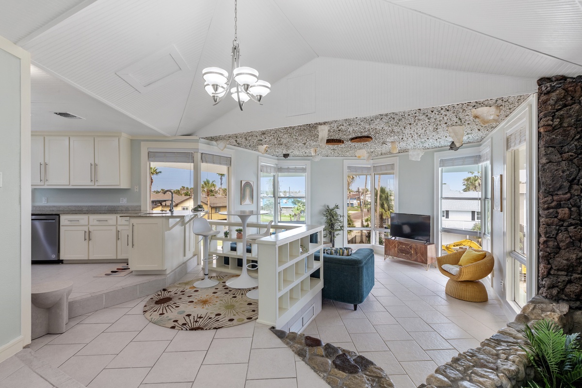 Your open-concept living space blends modern comfort with tropical charm, where natural light floods through expansive windows.