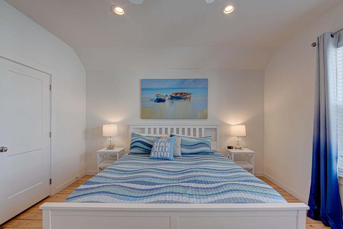 Drift off in this serene bedroom with ocean-inspired decor, soft lighting, and coastal artwork that whispers of seaside dreams.