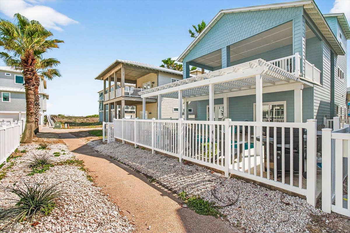 Charming coastal vacation homes featuring tropical palms and modern beach architecture in a peaceful waterfront community.