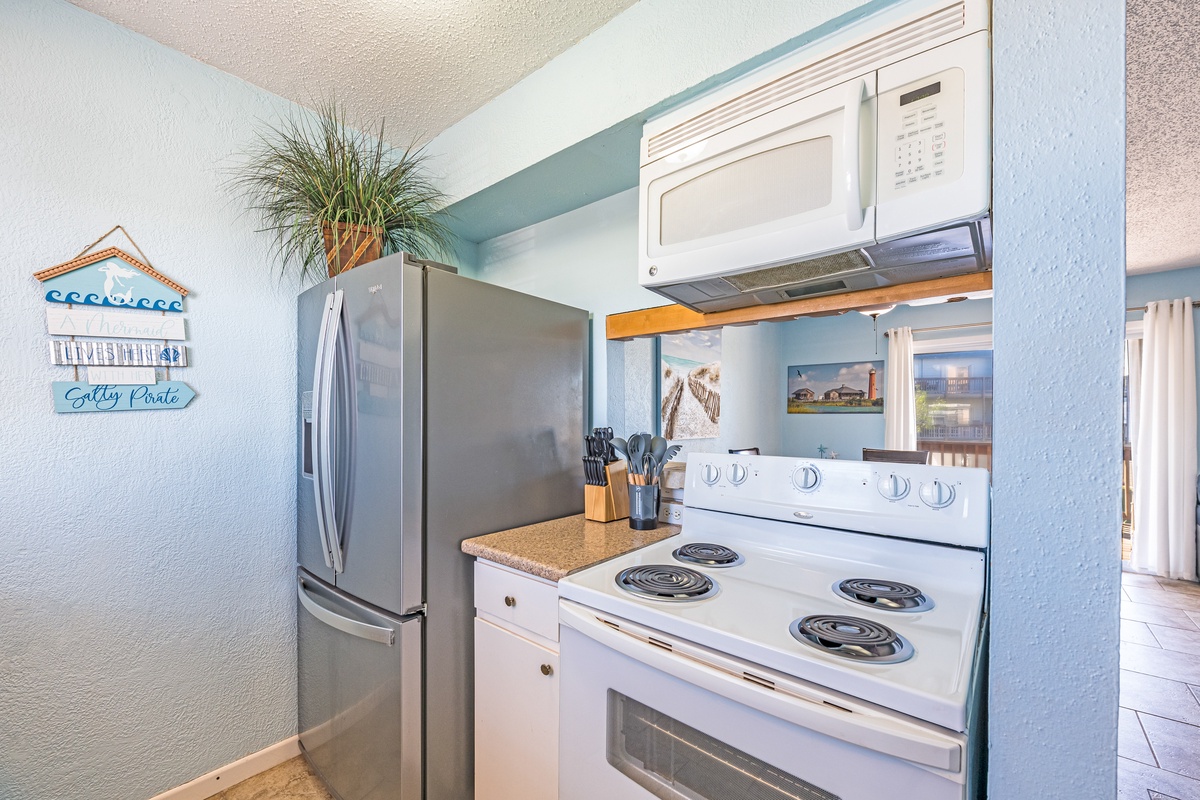 Your fully equipped kitchen features modern appliances and coastal charm, making meal prep feel like a breeze during your stay.
