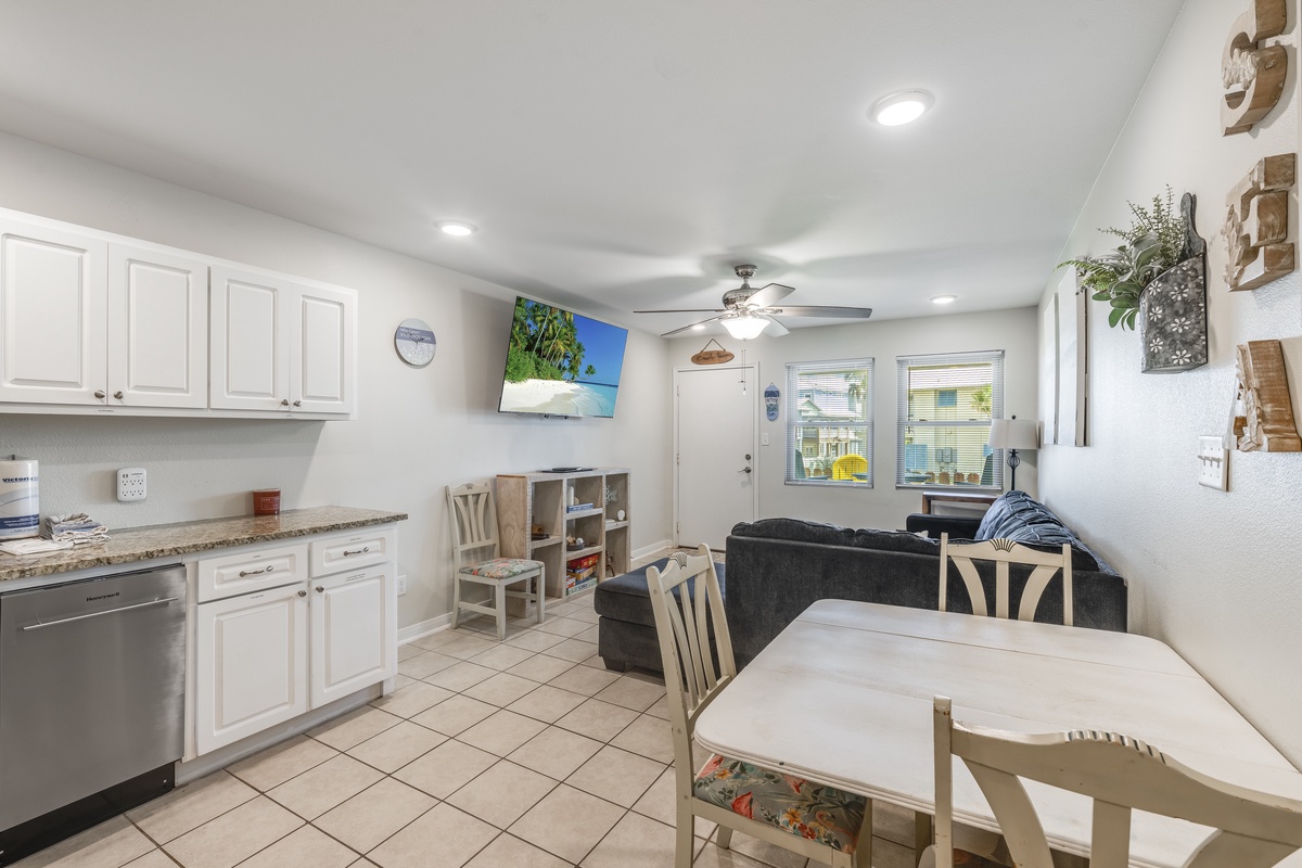 Unwind in your bright, airy living space where modern comfort meets coastal charm—complete kitchen, cozy seating, and tropical vibes await.