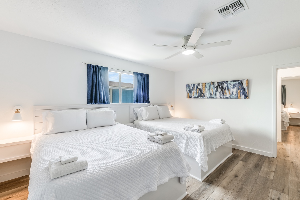 Drift off in your serene bedroom with twin beds, crisp linens, and modern touches that create the perfect restful retreat.