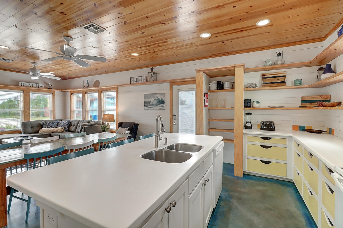 Your spacious kitchen invites culinary adventures with gleaming countertops, modern appliances, and an open layout that flows seamlessly into the cozy living area.