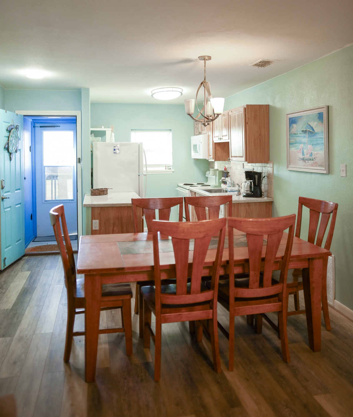 Gather around your spacious dining table for memorable meals in this welcoming kitchen space with calming coastal colors and all the essentials.