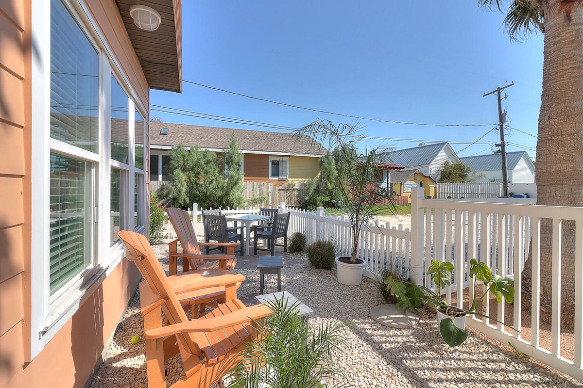 Step onto your private patio where Adirondack chairs invite morning coffee moments and outdoor dining awaits under endless blue skies.