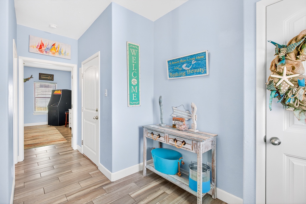 Step into your coastal haven with beachy blue walls and charming nautical touches that instantly transport you to seaside serenity.