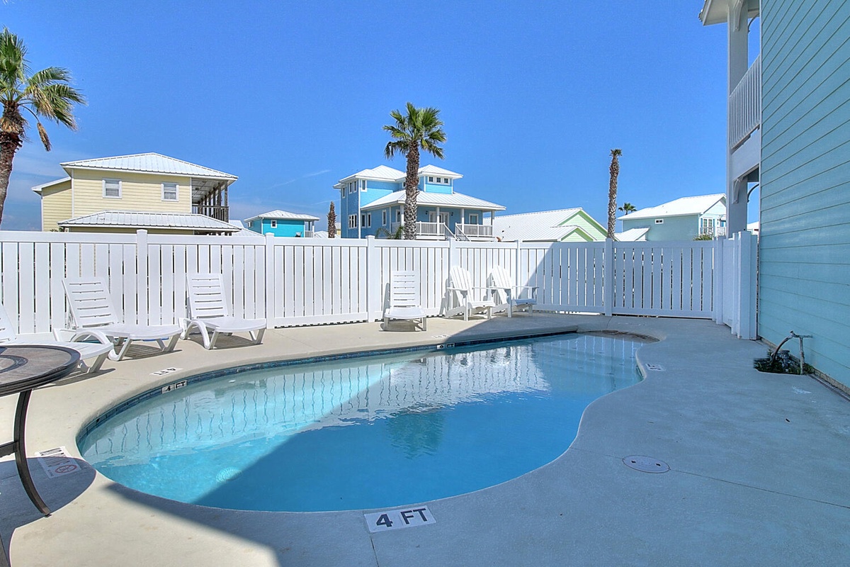 Dive into your own private oasis with this sparkling pool surrounded by comfortable loungers for perfect sunny day relaxation.