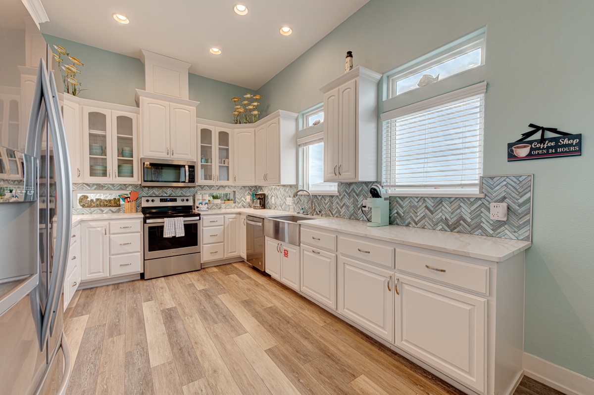 Your fully equipped kitchen features stainless steel appliances, beautiful tile backsplash, and plenty of counter space for preparing memorable meals together.