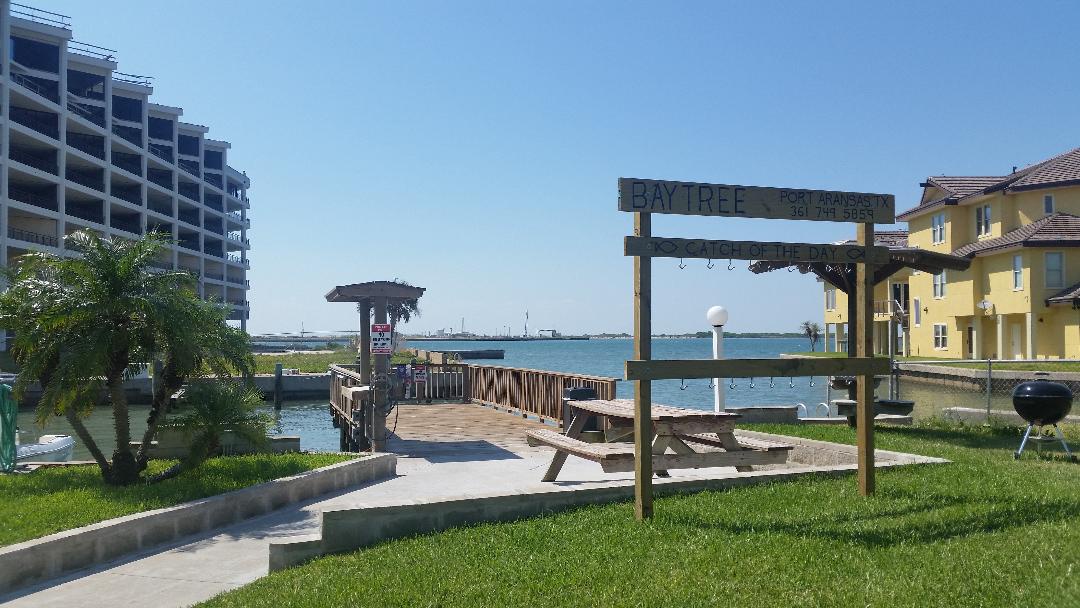 Baytree waterfront community features a private fishing pier and bay access, surrounded by residential buildings and coastal views.