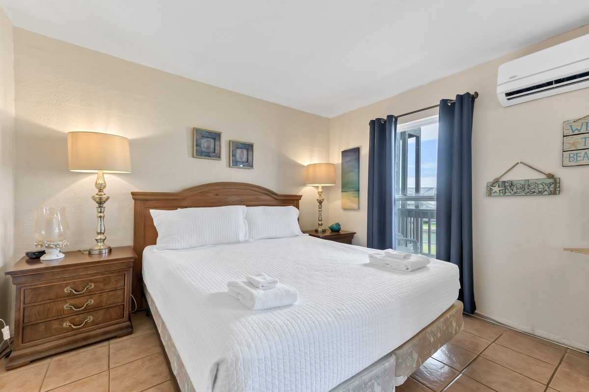Sink into crisp white linens and let the golden bedside lamps create your perfect evening ambiance in this serene retreat.