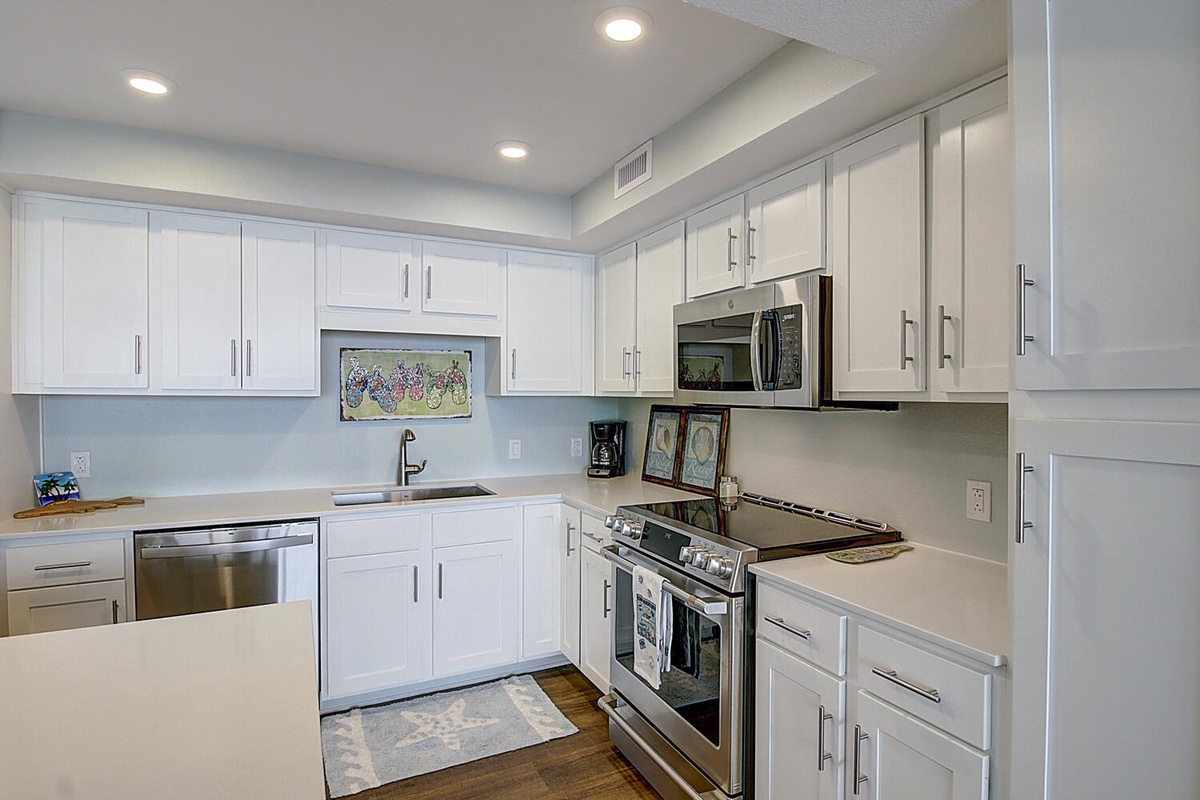 Your sleek kitchen features crisp white cabinets, stainless steel appliances, and clean countertops perfect for preparing your favorite meals.