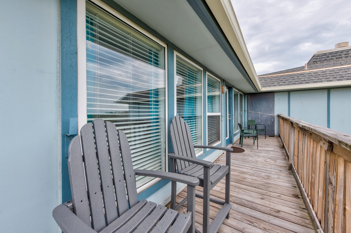 Relax in your private Adirondack chairs on this spacious wooden deck, where sliding glass doors invite gentle ocean breezes into your coastal retreat.