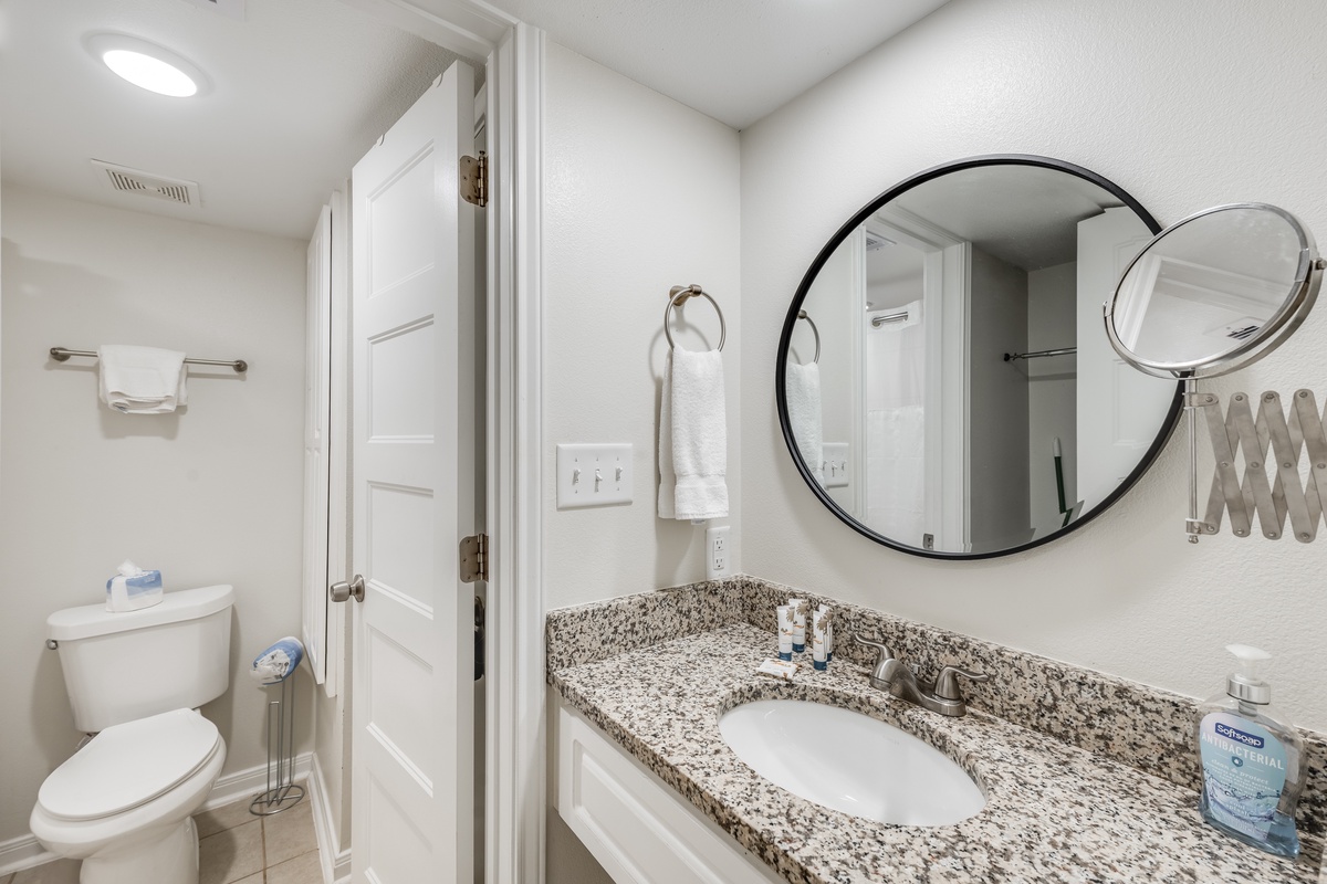 Your private bathroom features elegant granite counters, modern amenities, and thoughtful touches like a magnifying mirror for your convenience.