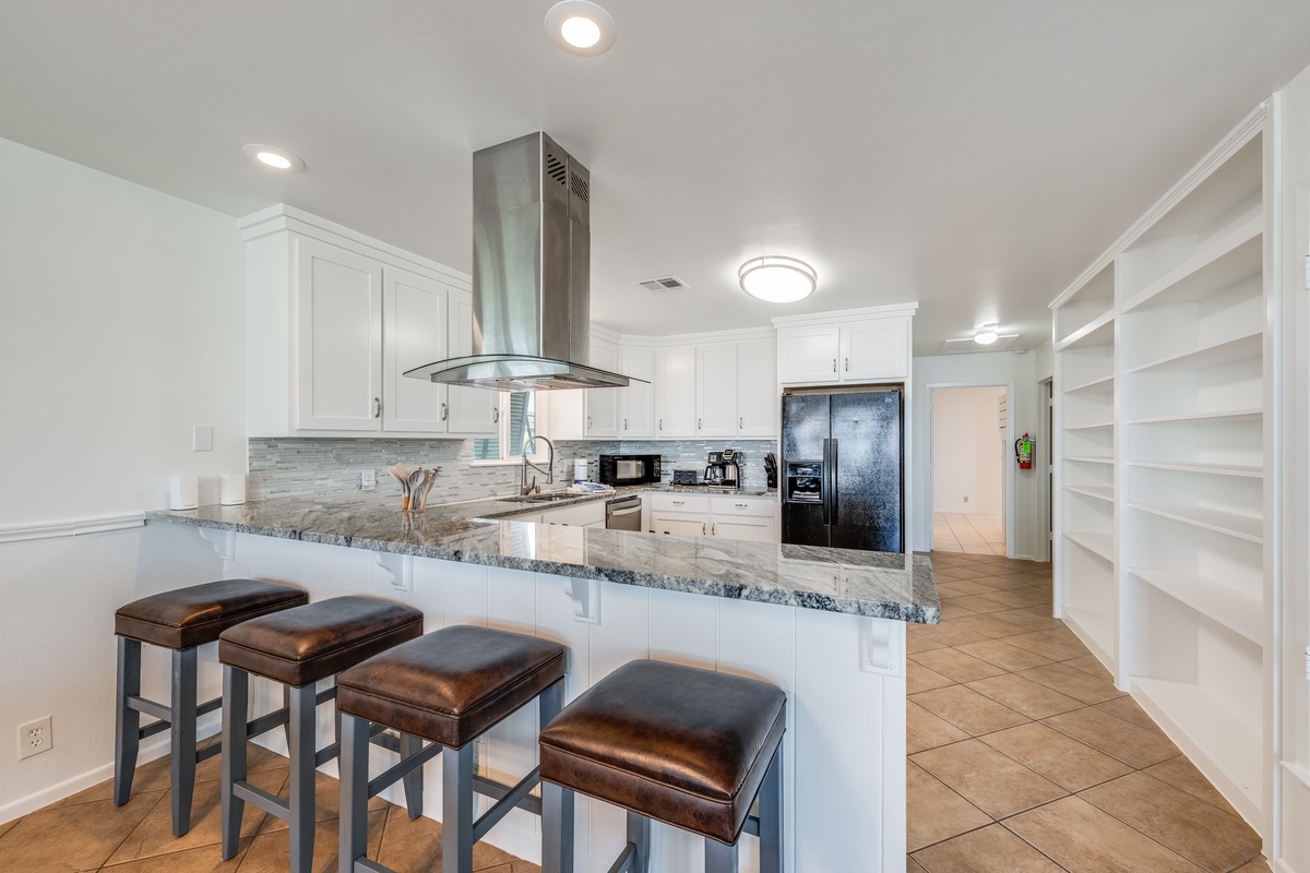 Your gourmet kitchen features granite counters, modern appliances, and breakfast bar seating for memorable culinary moments.