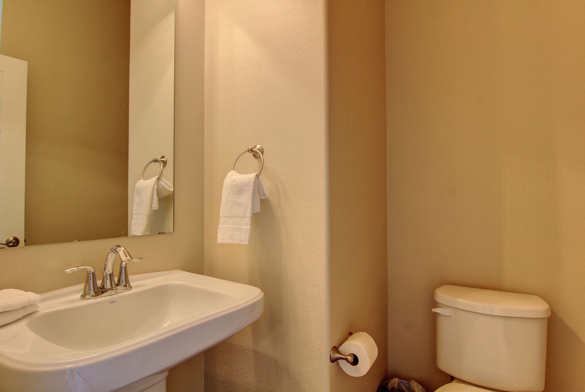 Your private bathroom features clean lines and warm tones, with fresh towels waiting for your arrival.