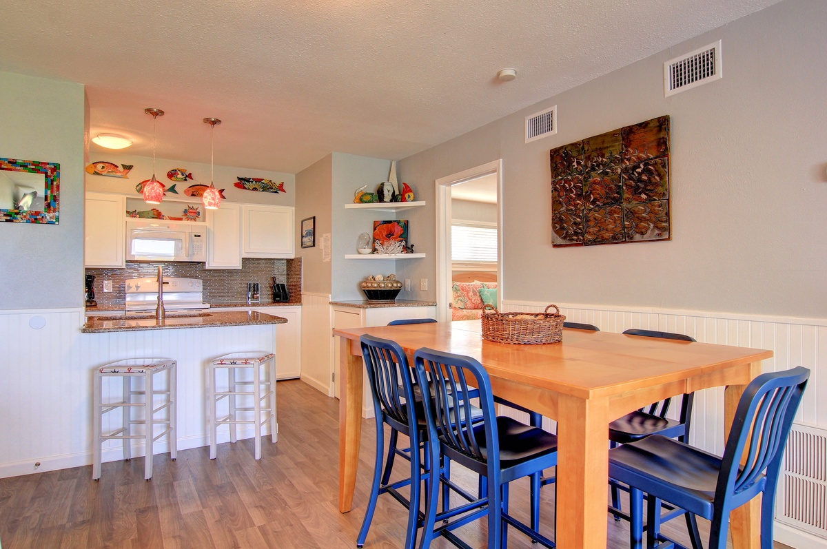 Gather around this inviting dining table where meals become memories, with a fully equipped kitchen ready for your culinary adventures.