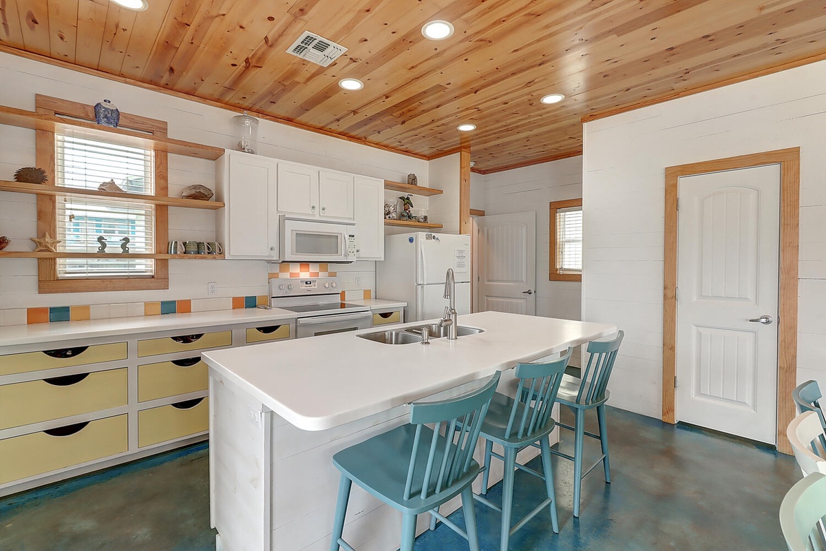 Your rustic-chic kitchen features warm wood ceilings, colorful island seating, and everything you need to create memorable meals together.