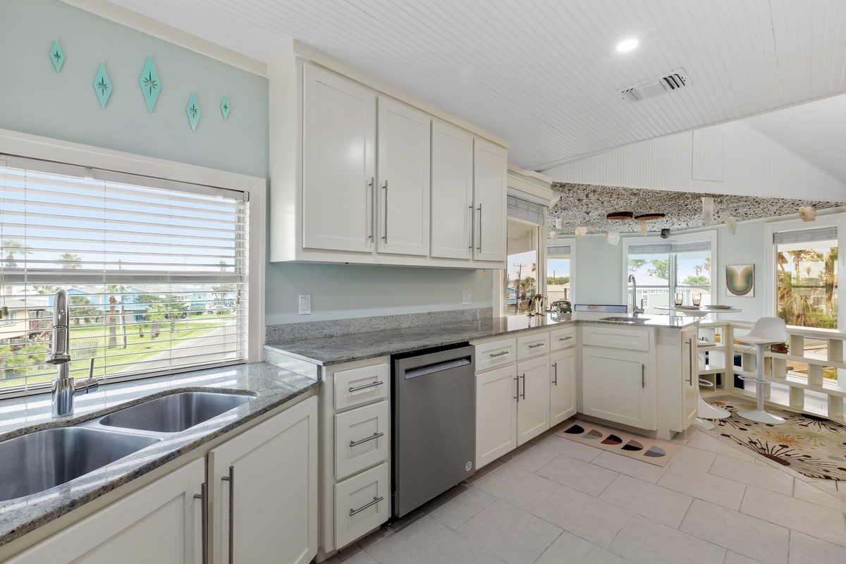 Your bright, fully-equipped second kitchen features modern appliances and granite counters, perfect for preparing meals while enjoying views of the surrounding area.