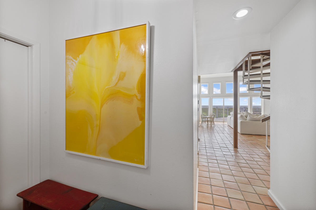 Step into your stylish retreat where vibrant art adorns clean walls and natural light flows through to the living area.