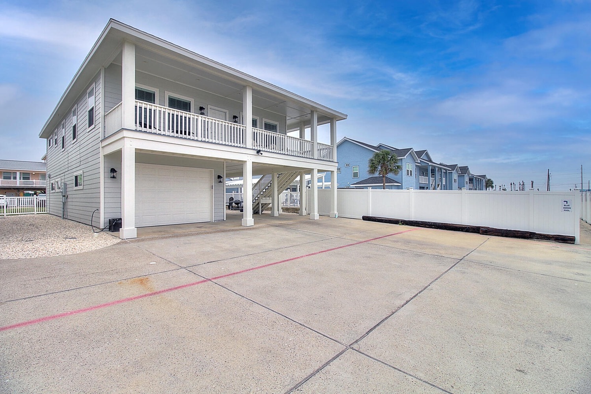 Modern coastal home with spacious sports court and covered parking in a quiet residential neighborhood.