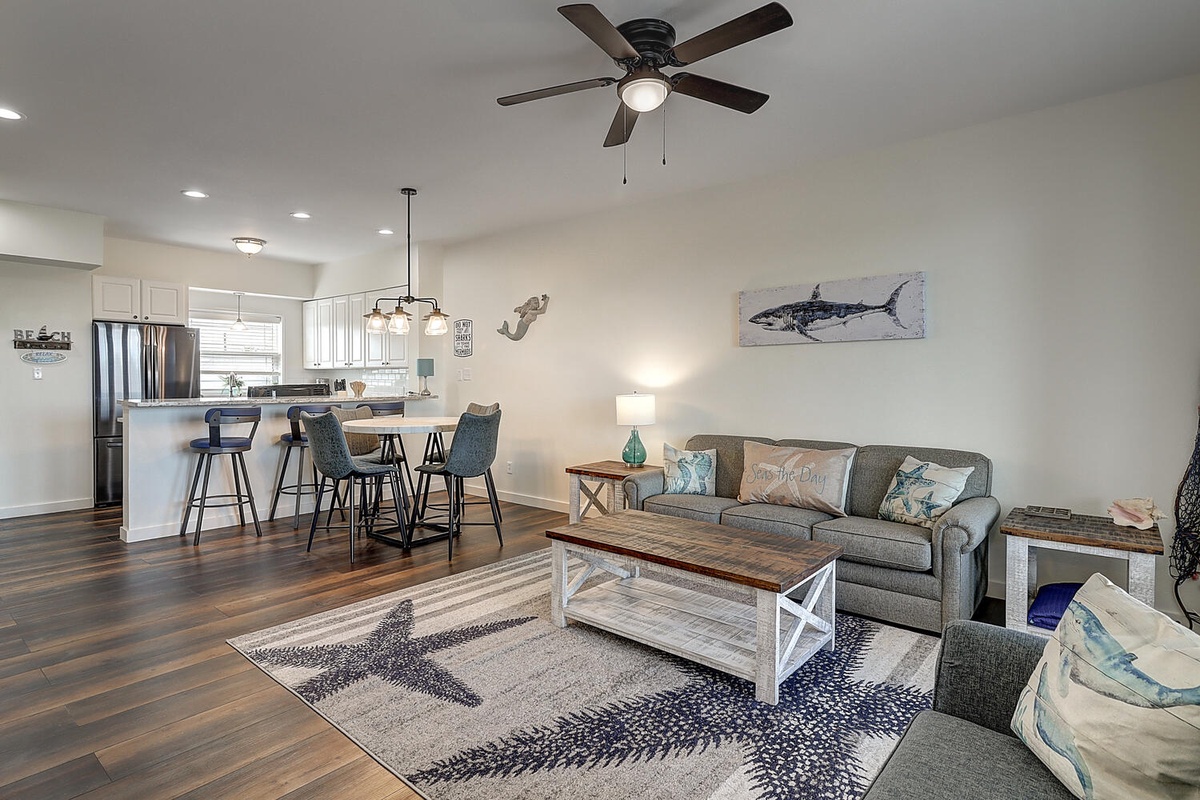 Relax in your coastal-themed living space where comfortable seating meets stylish nautical decor, perfect for unwinding after beach adventures.