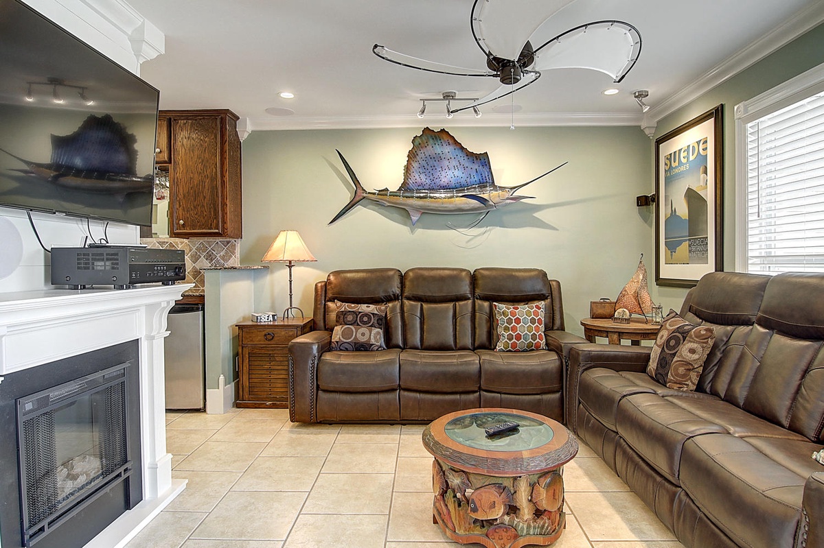 Your coastal retreat features plush leather seating, nautical artwork, and a warm fireplace—perfect for unwinding after beach adventures.