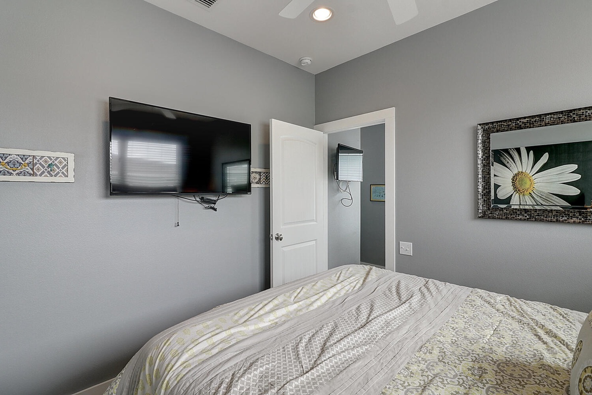 Relax in your serene bedroom with soothing gray walls and artwork creating a peaceful retreat for restful nights.