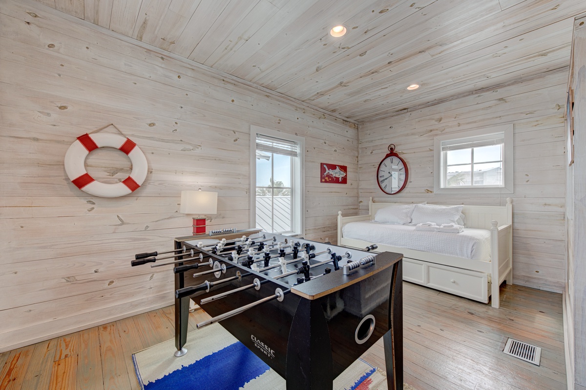 Challenge friends to foosball in your cozy coastal-themed retreat, where nautical charm meets endless entertainment.