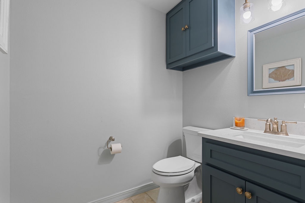 Refresh in your private bathroom with elegant teal cabinetry and gleaming white countertops, perfectly appointed for your comfort.