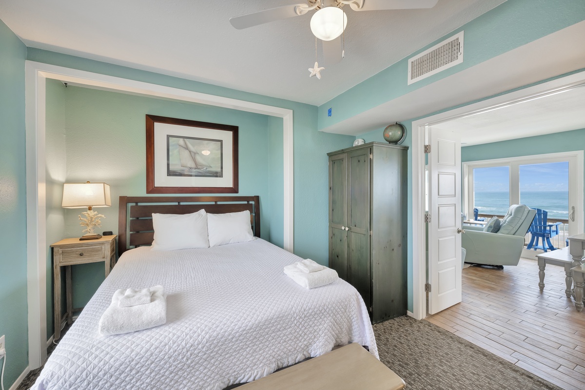 Wake up refreshed in your serene coastal bedroom, where calming aqua walls and ocean views create the perfect retreat for restful nights.