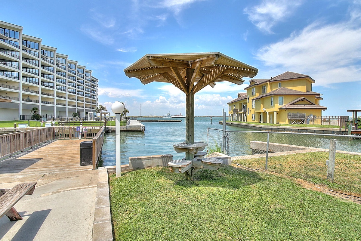 Waterfront marina setting with modern condos and docks, providing scenic harbor views and convenient boat access.